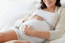 Pregnant woman on her bed