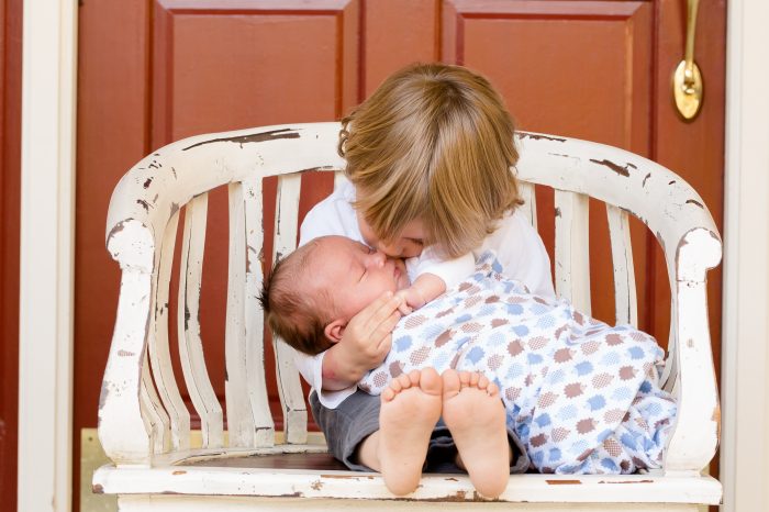 Child Kissing their Baby Sibling