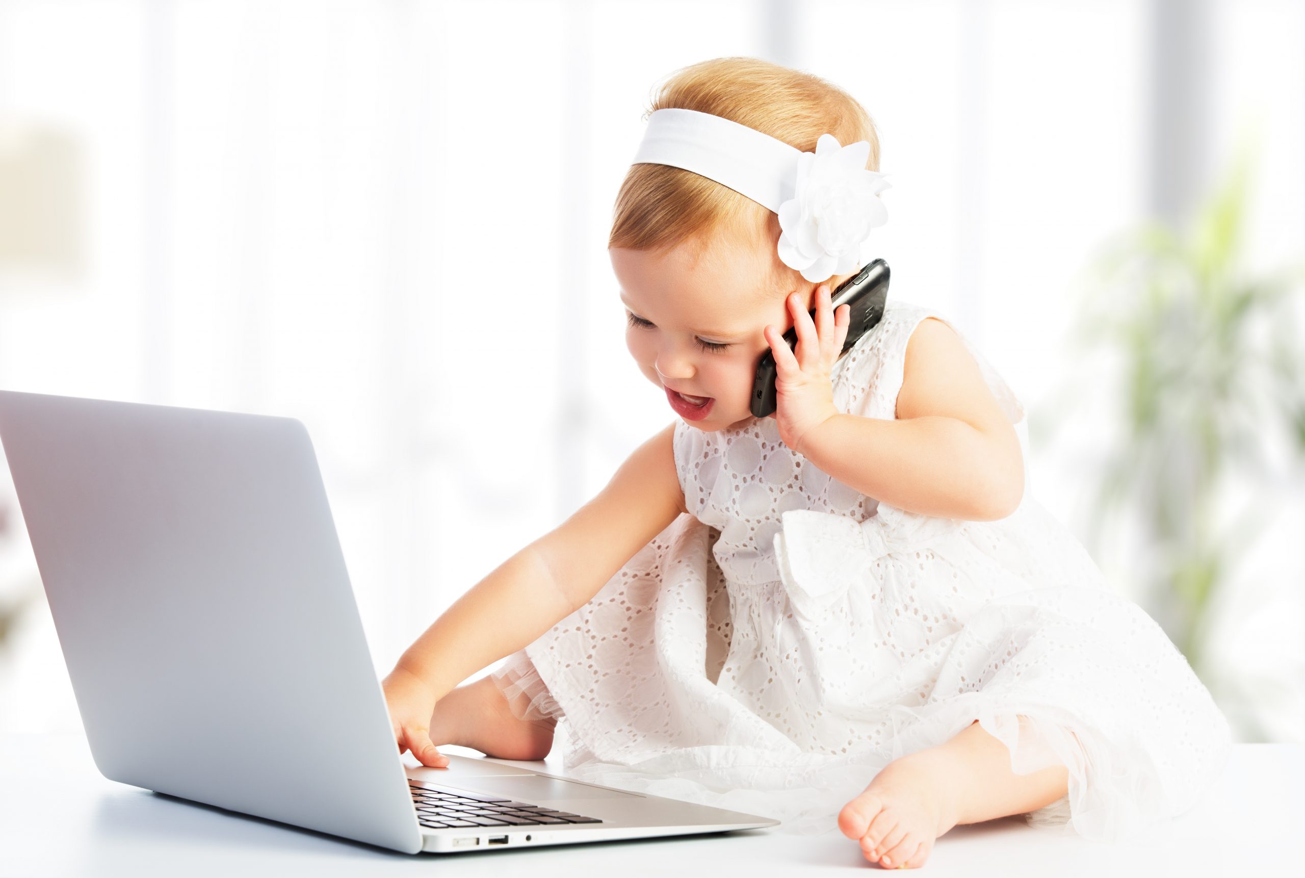 Baby Girl Dressed Smart Playing With Laptop and Phone