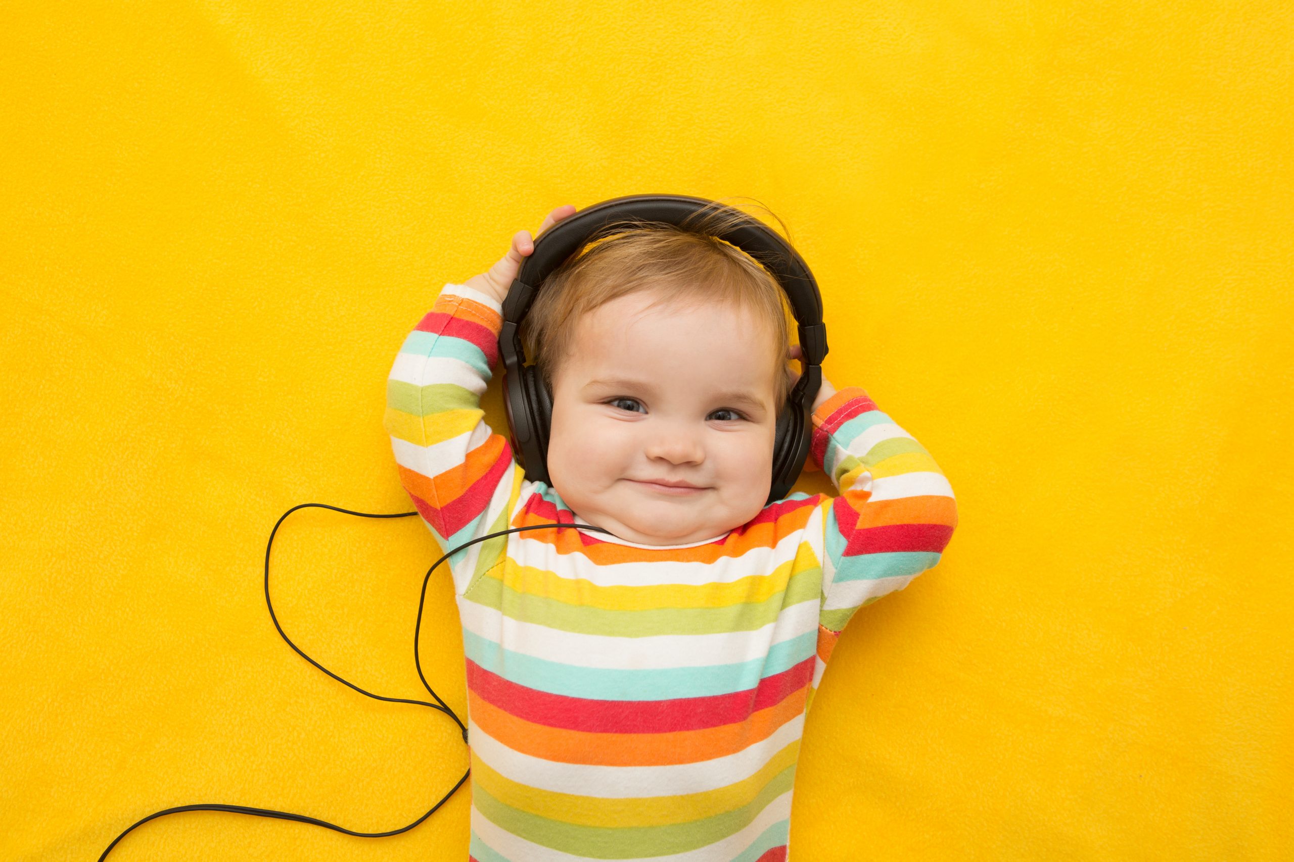 Baby Smiling with Headphones On